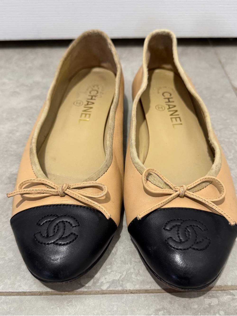CHANEL Beige Leather Ballet Flats with Black Cap Toe and CC Logo